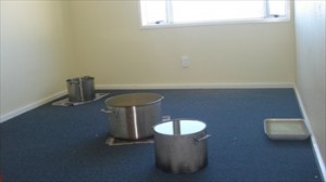 Pots collecting water from the open roof