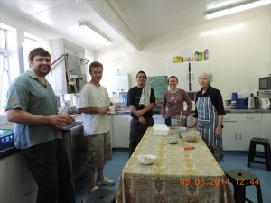 Community members having a well deserved break after preparing lunch.